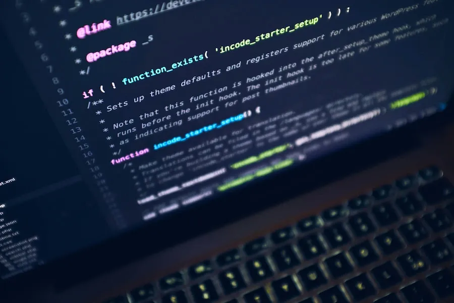 A laptop screen showing lines of code