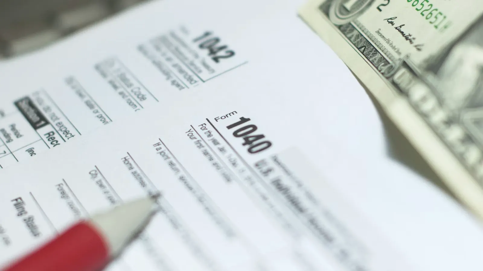 Financial forms with banknotes and a pencil