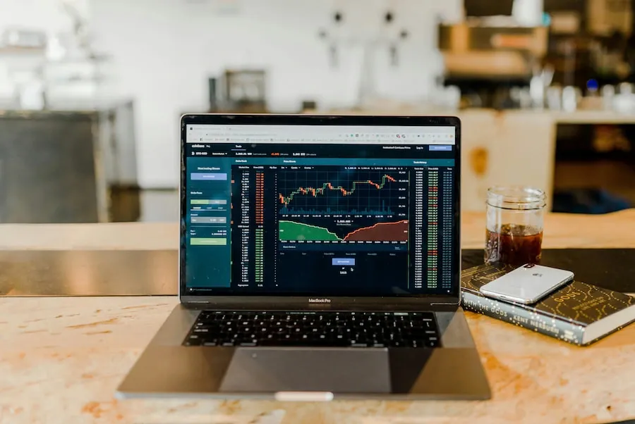 A trading workstation with a laptop showing market data