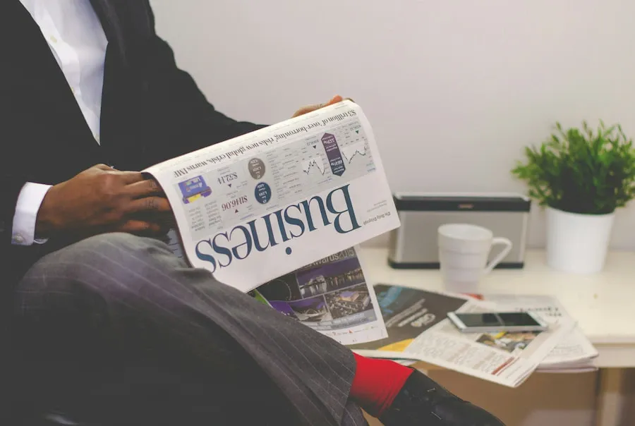 A person reading a financial newspaper