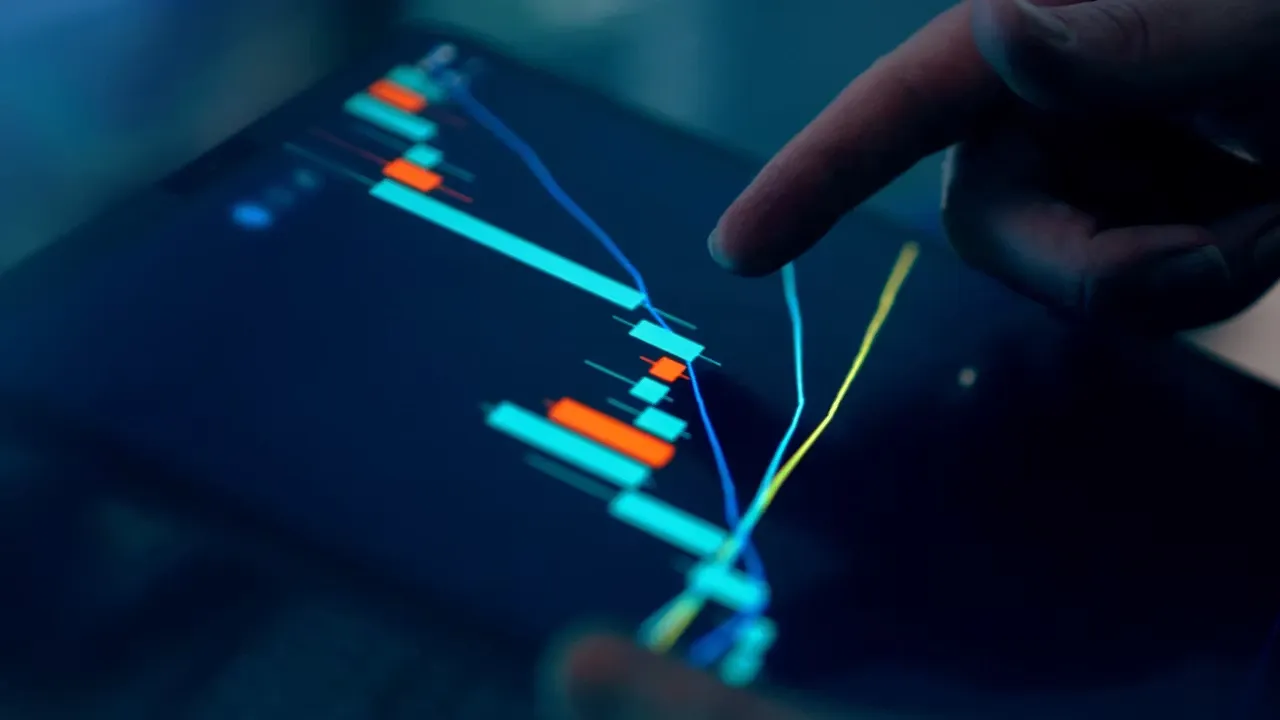 Trader adjusting an order on a tablet showing a market chart