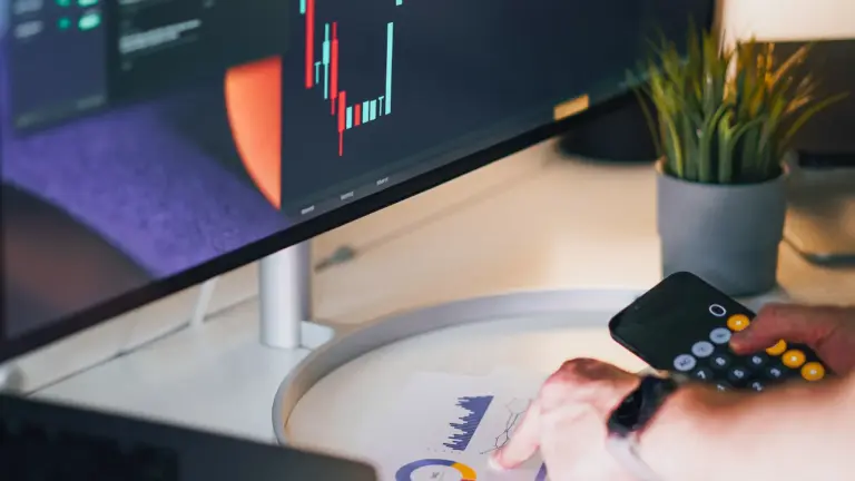 Trader analyzing strategy performance across chart-filled trading screens