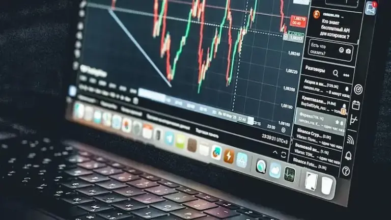 A laptop displaying a stock market trading chart