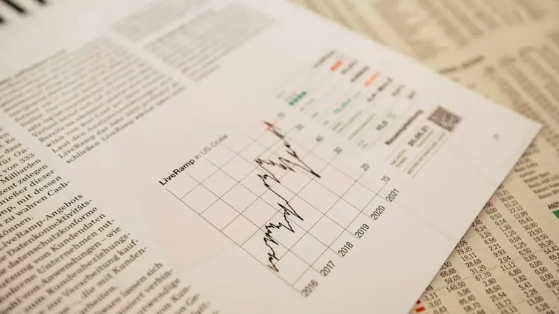 A financial newspaper with a stock chart