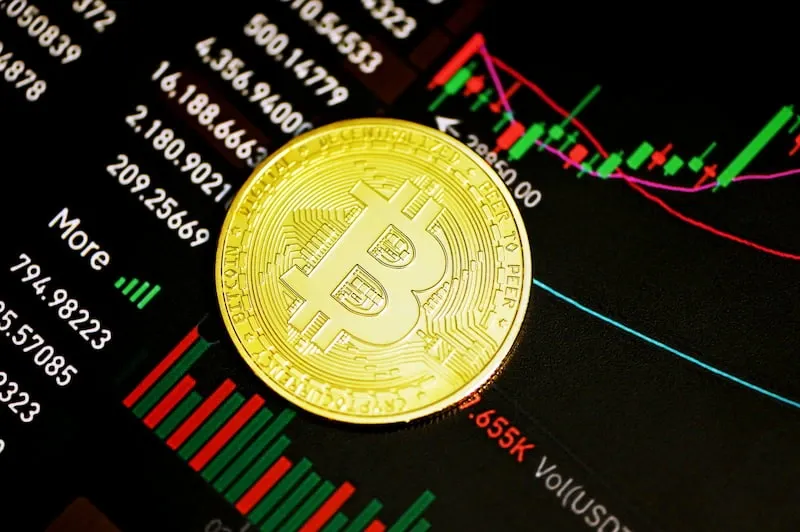 A gold coin on a black surface