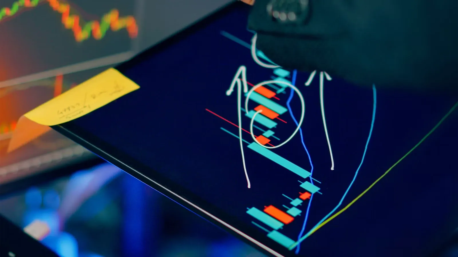 A trader analyzing charts on multiple screens