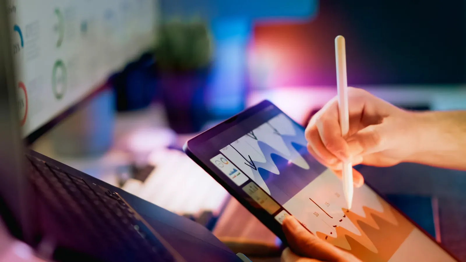 A stylus on a tablet showing charts