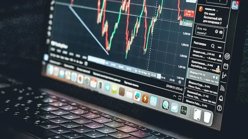 A laptop displaying a trading chart