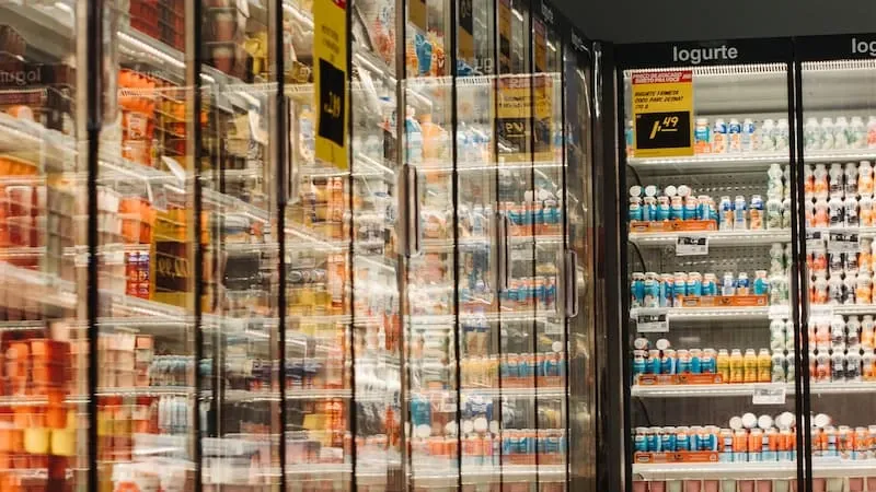 Refrigerated display cases filled with rows of products in a store