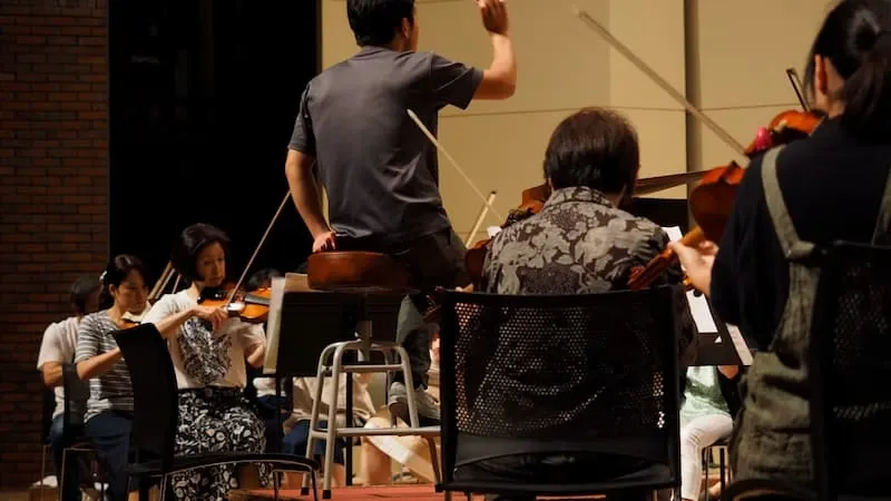 A conductor leading an orchestra