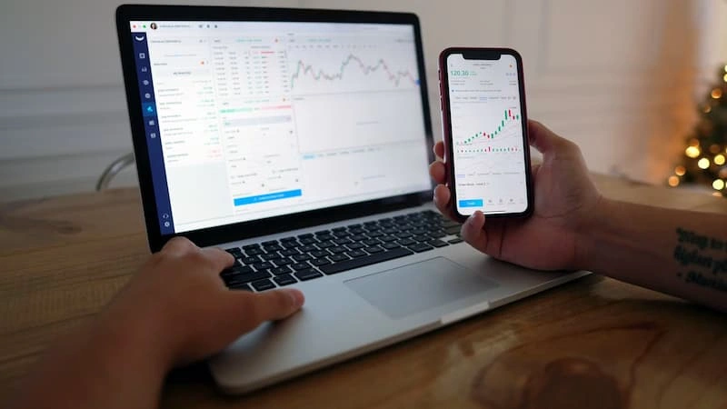 A laptop showing trading charts
