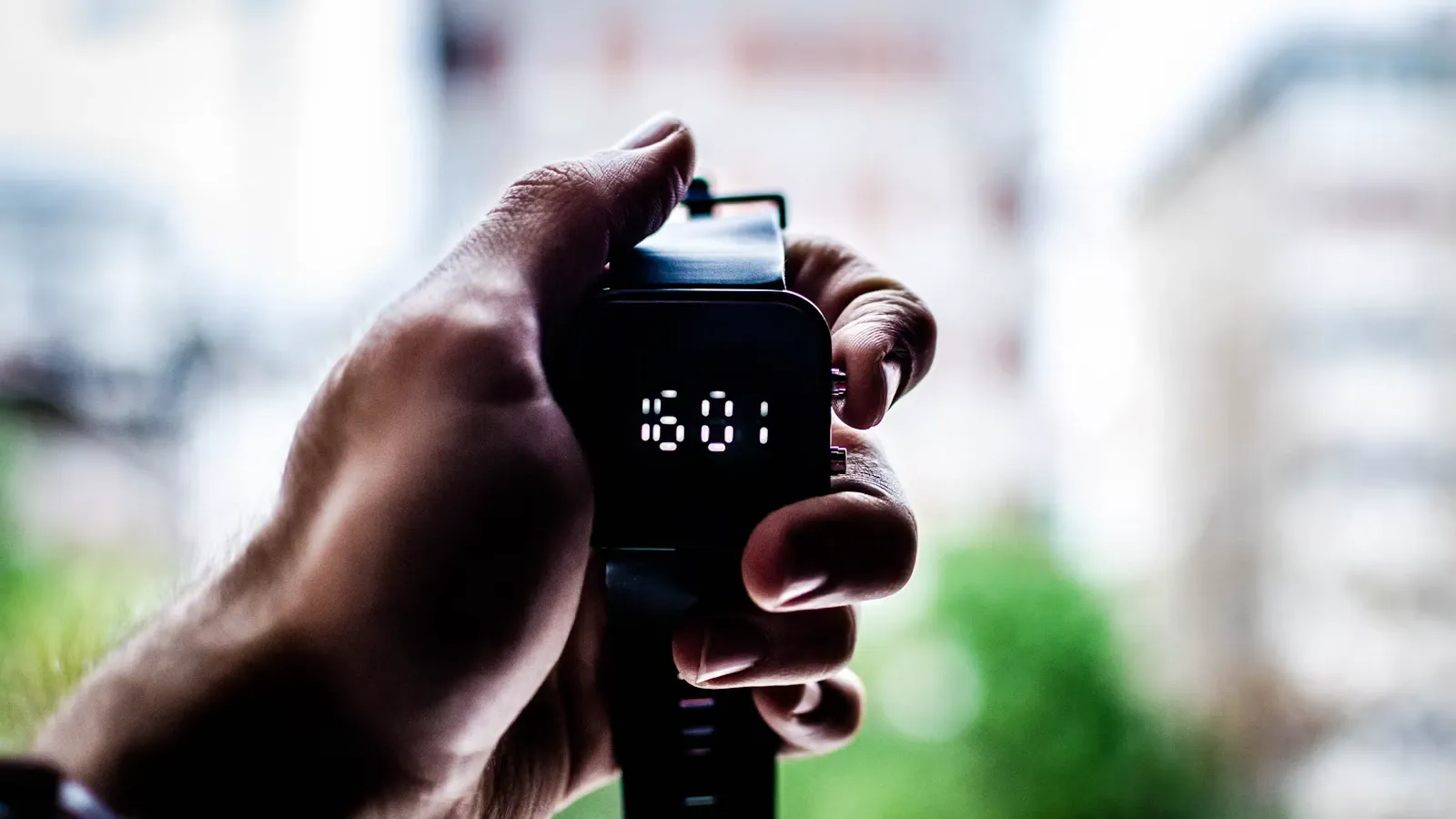 A person holding a digital watch