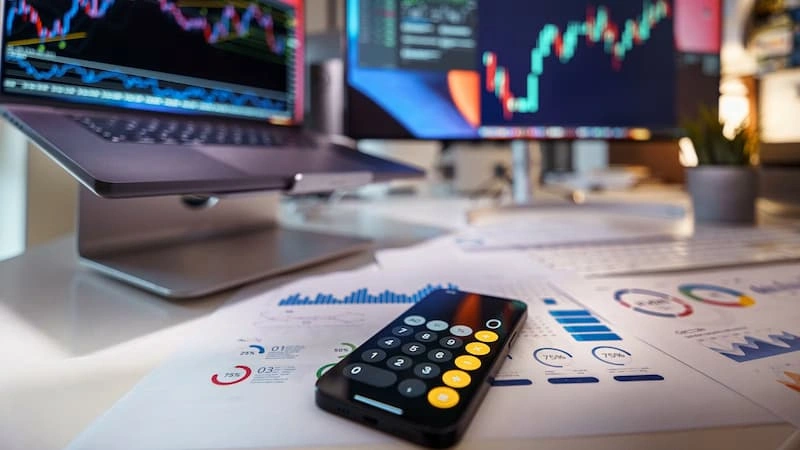 A calculator and phone with charts