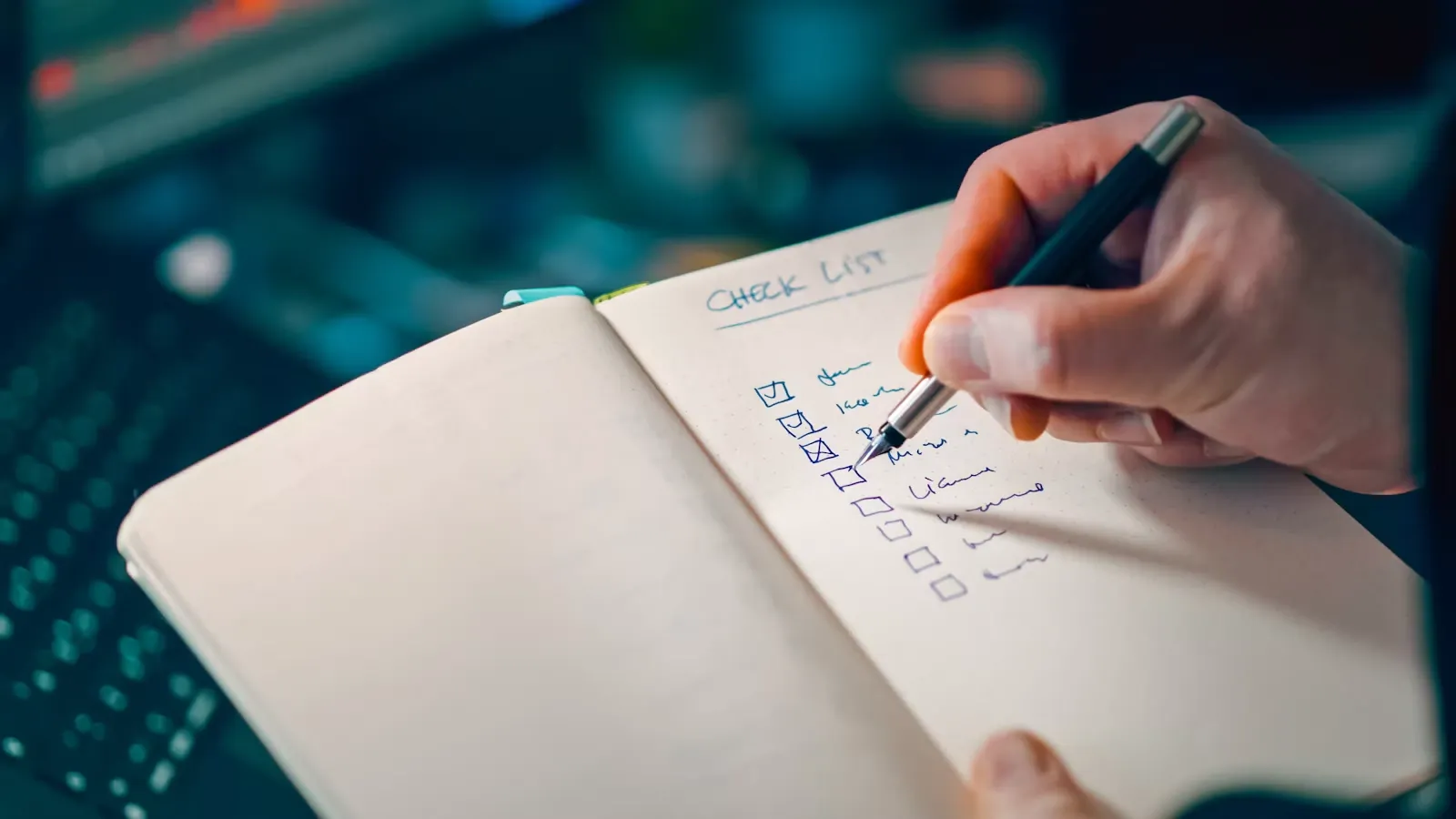 A hand writing a checklist
