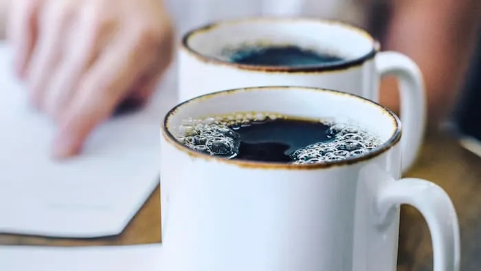 Two coffee cups side by side on a table