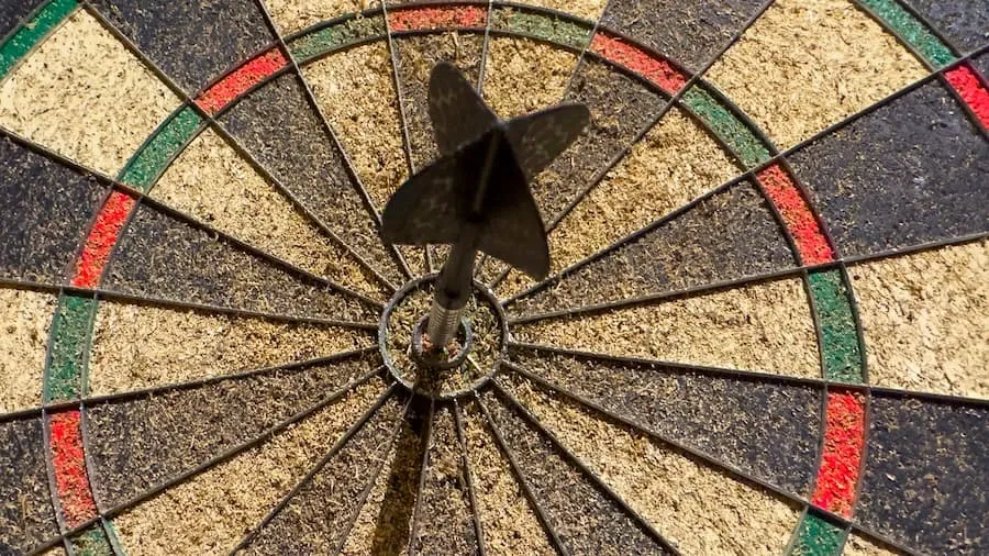 A dart hitting the bullseye on a dartboard