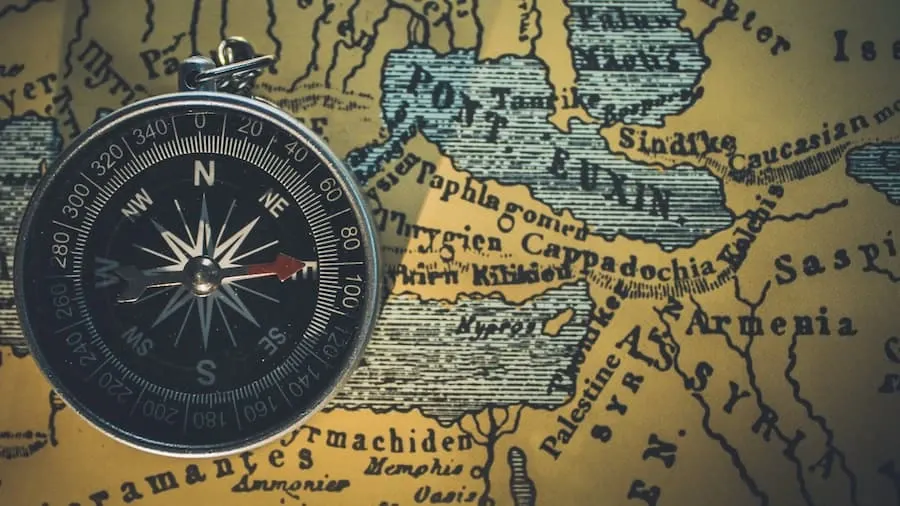 A compass resting on a folded map