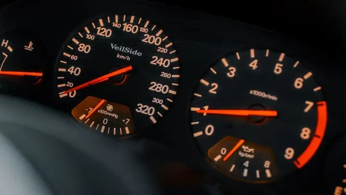 A car dashboard speedometer and tachometer