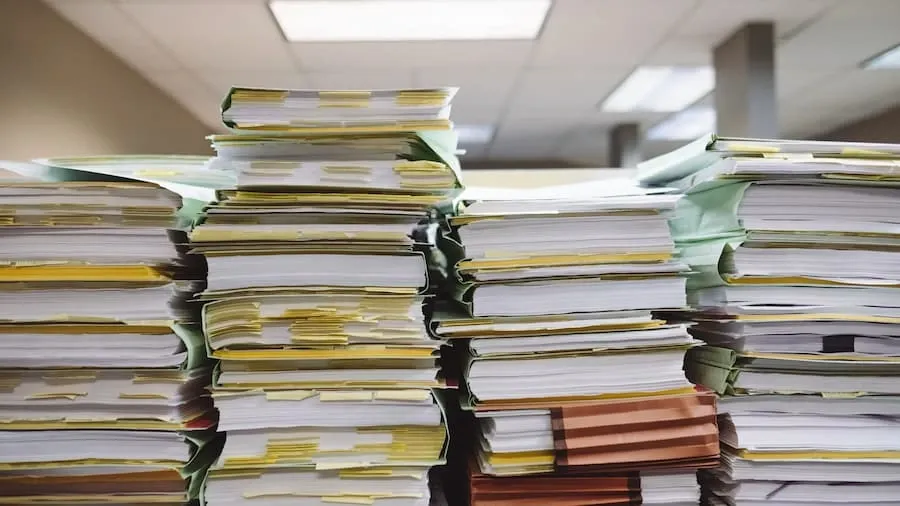 Stacks of paper documents and file folders