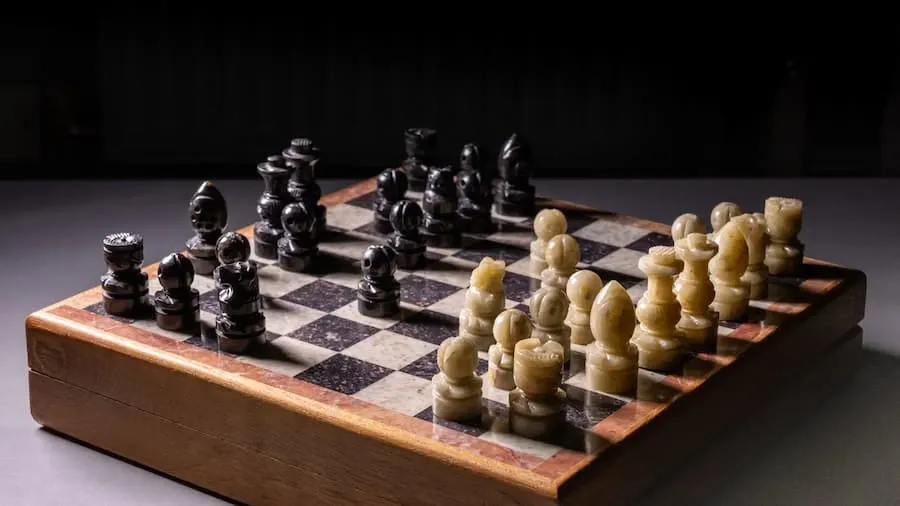 A wooden chess board with pieces mid-game