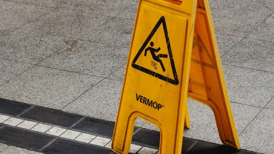 A yellow caution sign beside a road